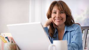 A smiling businesswoman at her laptop